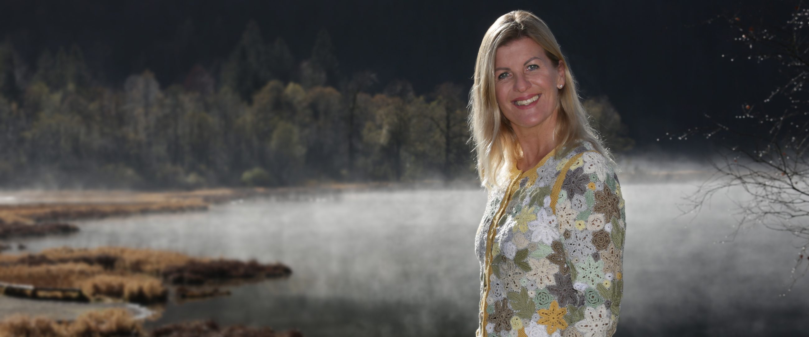 Andrea Wittmann standing by Klostersee lake near Seeon Abbey, morning mist over the water