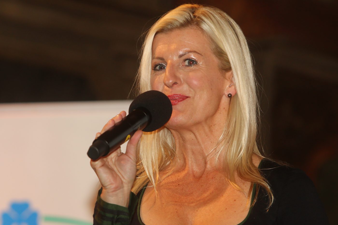 Andrea Wittmann moderiert, das Mikrofon in der Hand, im Gespräch mit dem Publikum
